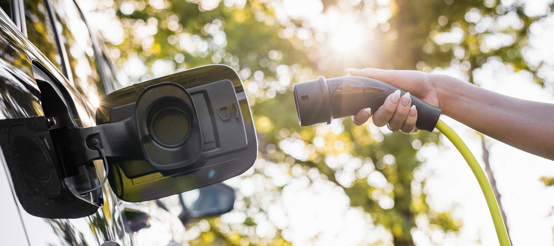 a person plugging the ev charger into their car